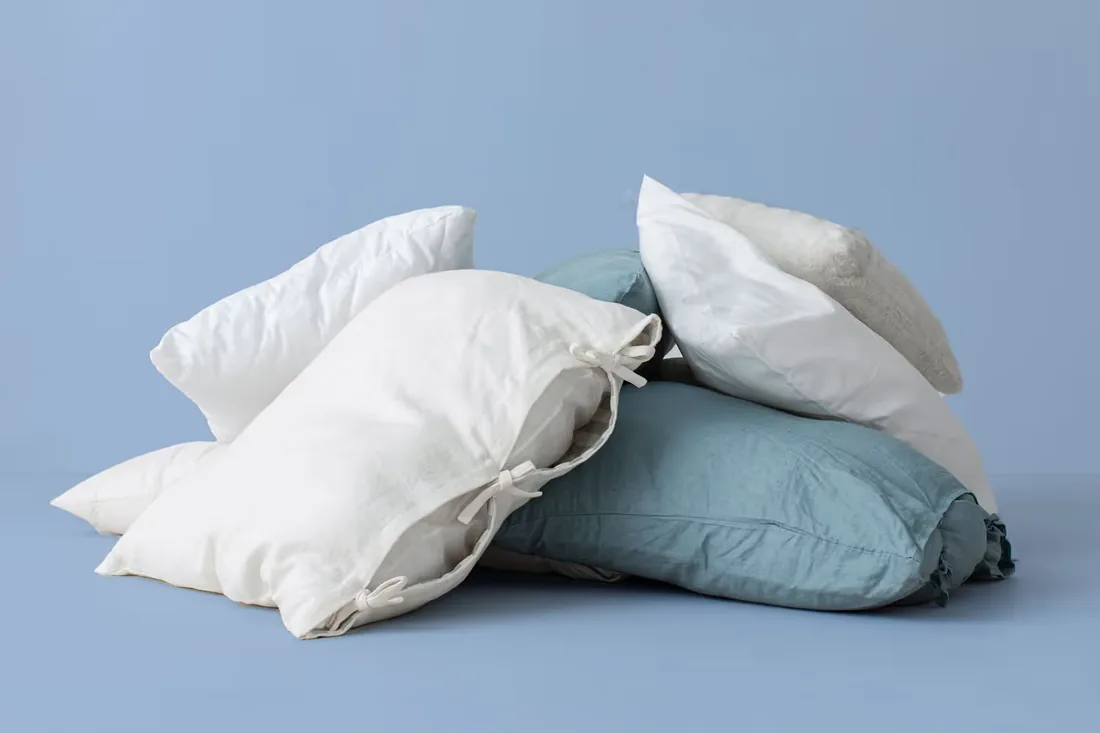 Stack of white pillows on a blue background