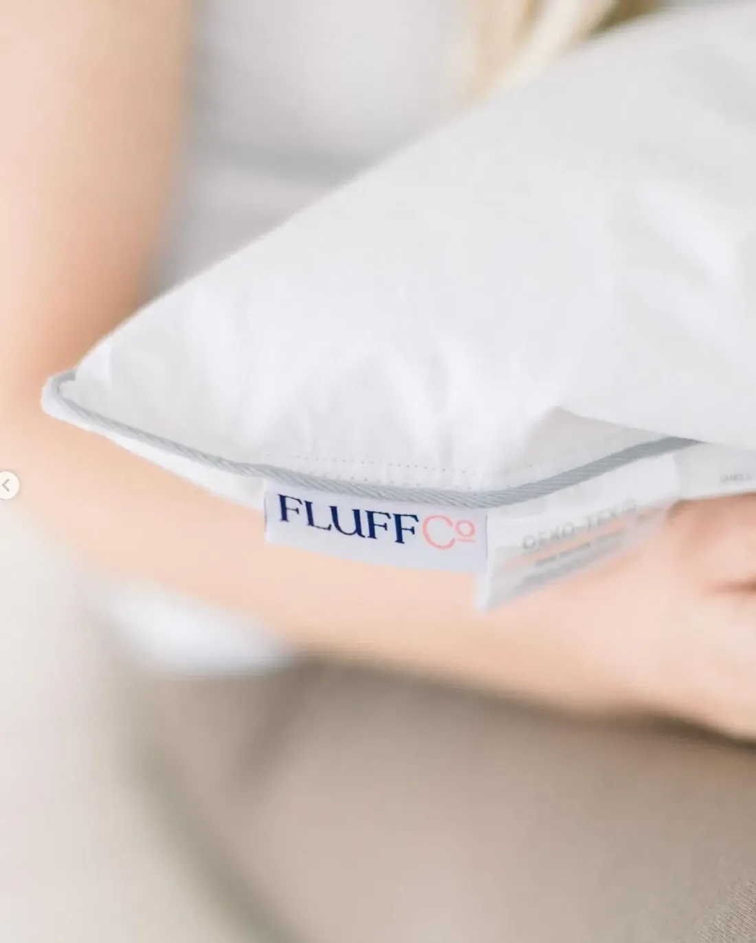 White FluffCo pillow with its label