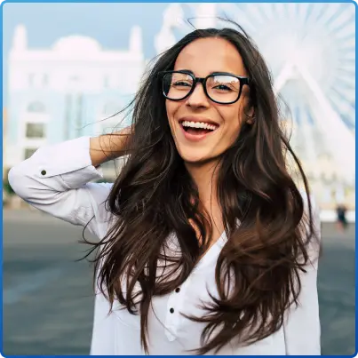 Woman smiling while wearing smart glasses outdoors