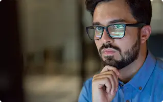 Man wearing smart glasses looking at a screen
