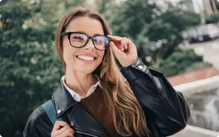 Woman wearing glasses in an urban setting