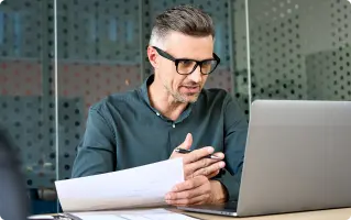 Man working at a laptop wearing glasses