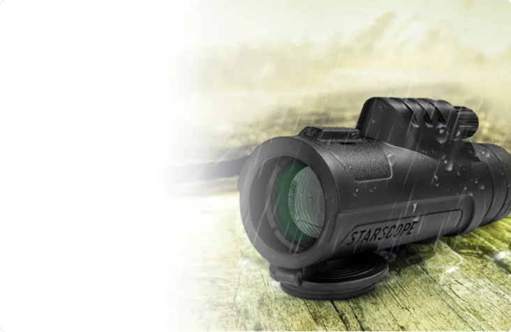Monocular resting on a wooden railing outdoors